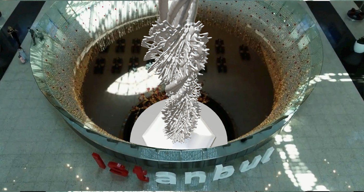 View from the upper level: the sculpture rising through the circular void of the terminal